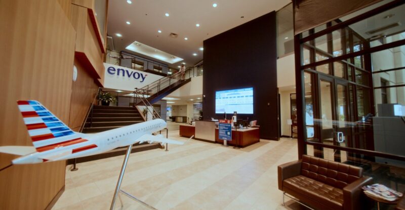 Inside the Enjoy Air headquarters. A model regional jet is seen in the foreground and a large Samsung display is in the background.
